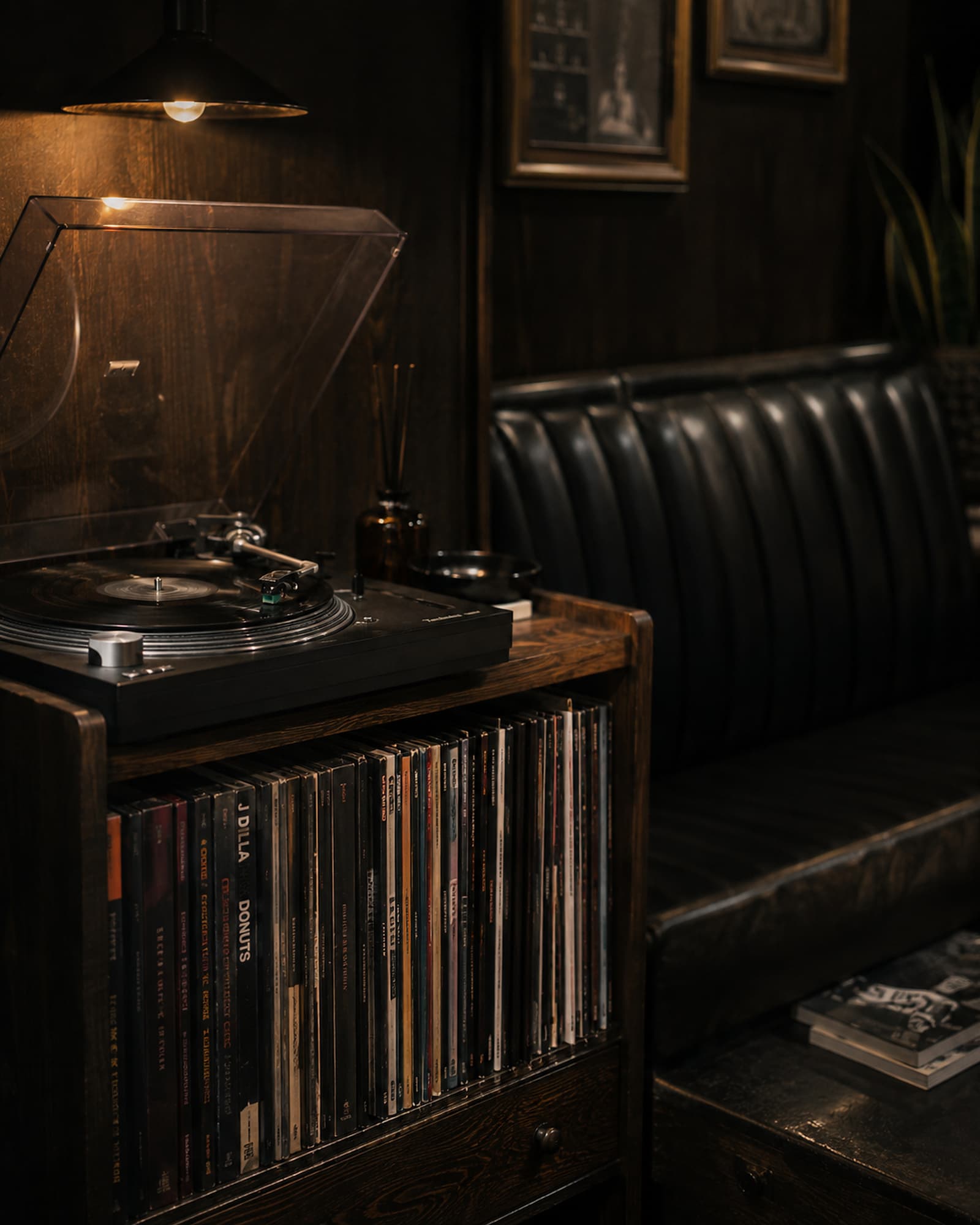 Record player and shelf of LPs beside the waiting bench
