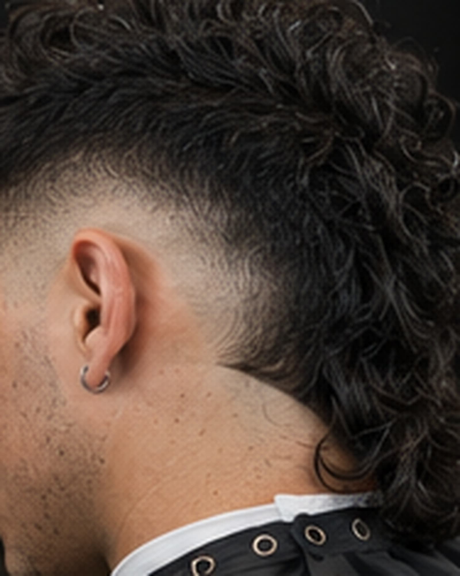 Burst fade radiating around the ear into a longer back