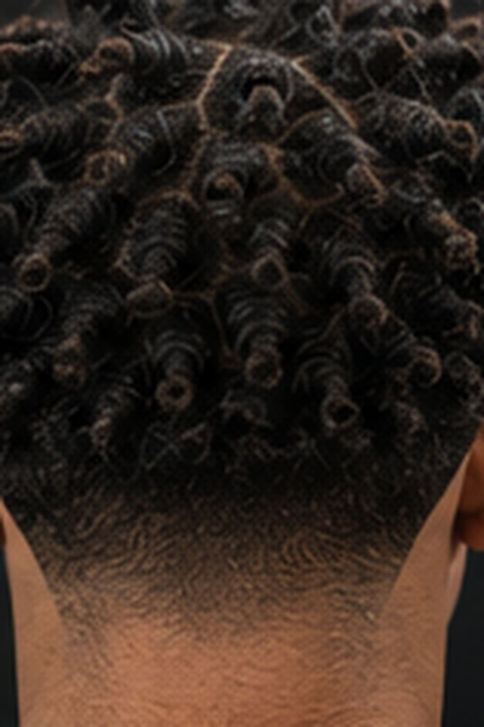 Twist-out curl definition over a clean taper at the nape