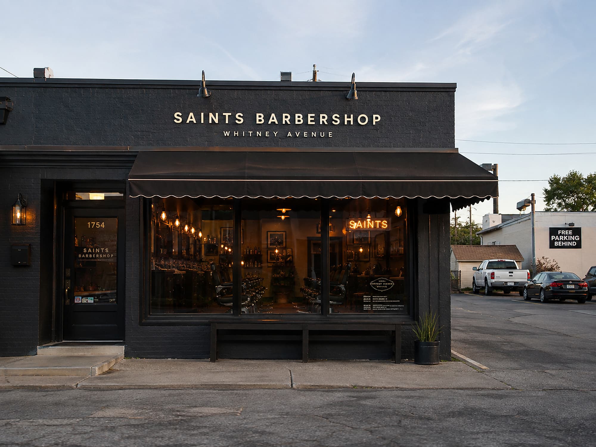 The Whitney Avenue shopfront in the morning, awning out, lot behind